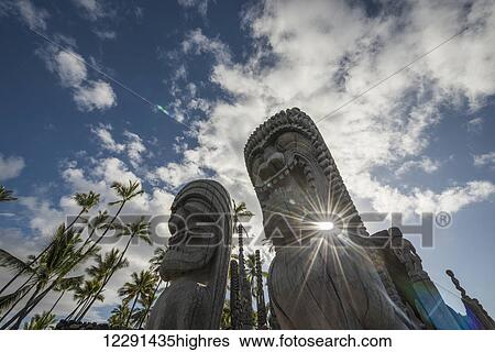 Afternoon sun shines through statues at Puuhonua O Honaunau National Historic Park; Island of Hawaii, Hawaii, United States of America View Large Photo Image Stock Photograph - Afternoon sun shines through statues at Puuhonua O Honaunau National Historic Park; Island of Hawaii, Hawaii, United States of America. Fotosearch