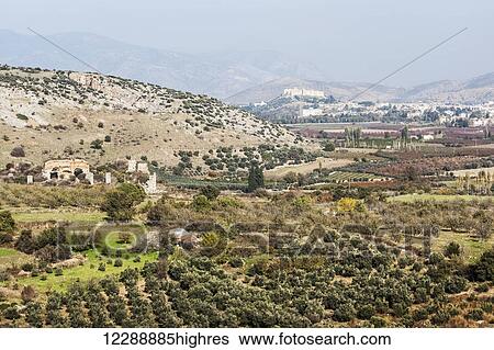 Stock Photograph - An ancient wall and landscape of Selcuk, near the ancient city of Ephesus; Ephesus, Turkey. Fotosearch