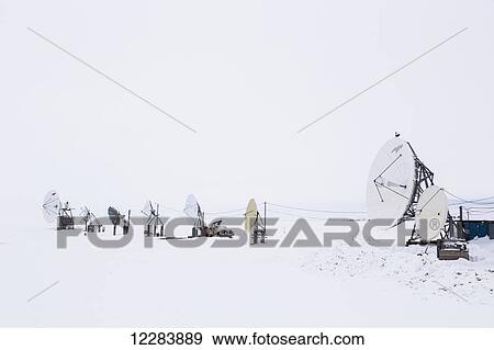 An array of satellite dishes pointing out to the ocean, Barrow, North Slope, Arctic Alaska, USA, Winter View Large Photo Image Stock Photo - An array of satellite dishes pointing out to the ocean, Barrow, North Slope, Arctic Alaska, USA, Winter. Fotosearch