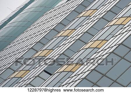 Stock Photograph - Angled green and yellow facade of skyscraper; Hong Kong, China. Fotosearch