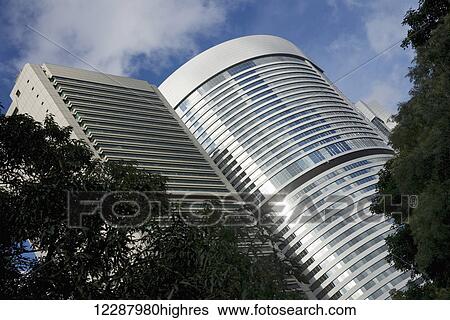 Stock Photograph - Angled view of office rotunda among trees; Hong Kong, China. Fotosearch