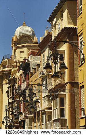 Stock Photograph - Apartment buildings with hanging street lanterns; Cartagena, Murcia province, Spain. Fotosearch