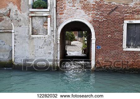Arched doorway in a brick wall on a canal; Venice, Italy View Large Photo Image Stock Image - Arched doorway in a brick wall on a canal; Venice, Italy. Fotosearch