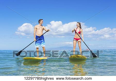 Attractive Couple Stand Up Paddling in Hawaii View Large Photo Image Stock Photograph - Attractive Couple Stand Up Paddling in Hawaii. Fotosearch