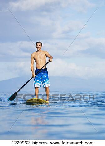 Attractive Man on Stand Up Paddle Board, SUP, Tropical Blue Ocean, Hawaii View Large Photo Image Stock Photograph - Attractive Man on Stand Up Paddle Board, SUP, Tropical Blue Ocean, Hawaii. Fotosearch
