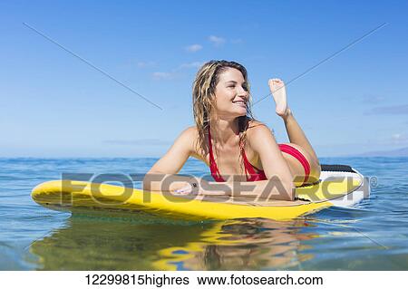 Stock Photograph - Attractive Woman on Stand Up Paddle Board, SUP, Tropical Blue Ocean, Hawaii. Fotosearch