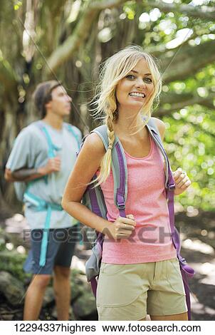 Stock Photograph - Attractive young couple having fun together outdoors on hike. Fotosearch