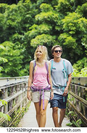 Stock Photograph - Attractive young couple having fun together outdoors on hike. Fotosearch