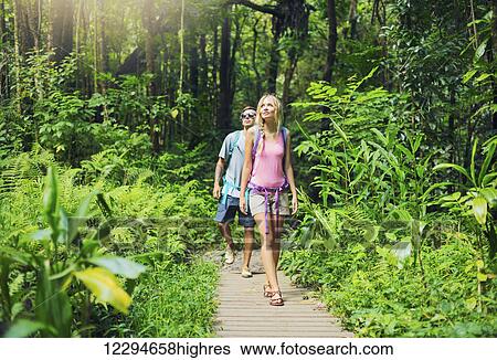Stock Photograph - Attractive young couple having fun together outdoors on hike. Fotosearch