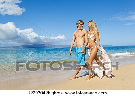 Stock Photograph - Attractive Young Couple on Tropical Beach. Fotosearch
