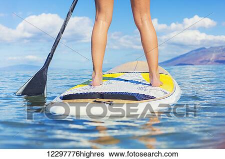 Attractive Young Woman Stand Up Paddle Surfing In Hawaii, Beautiful Tropical Ocean, Active Beach Lifestyle View Large Photo Image Stock Photograph - Attractive Young Woman Stand Up Paddle Surfing In Hawaii, Beautiful Tropical Ocean, Active Beach Lifestyle. Fotosearch