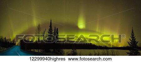 Stock Photograph - Aurora borealis over the road; Thunder Bay, Ontario, Canada. Fotosearch