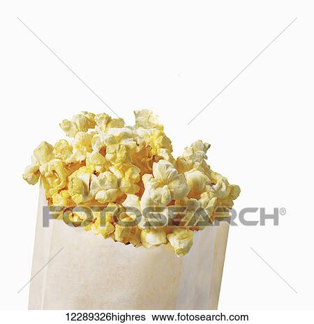 Stock Photograph - Bag of buttered popcorn on a white background; Toronto, Ontario, Canada. Fotosearch