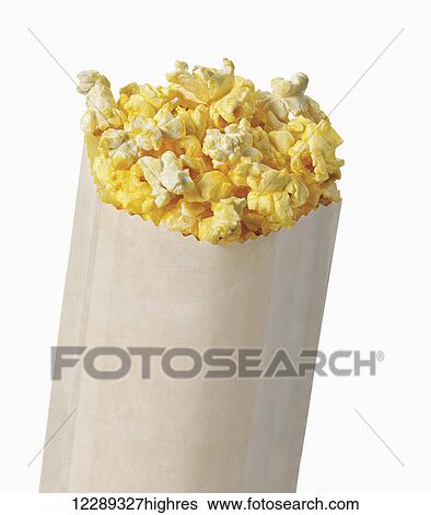 Stock Photograph - Bag of buttered popcorn on a white background; Toronto, Ontario, Canada. Fotosearch