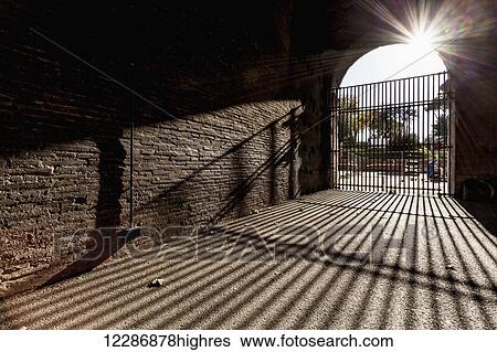 Bars at entrance closed and shadow cast on the ground; Rome, Italy View Large Photo Image Stock Photograph - Bars at entrance closed and shadow cast on the ground; Rome, Italy. Fotosearch