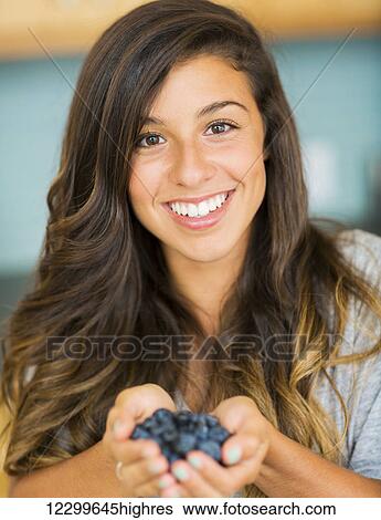 Beautiful Woman Holding a handfull of fresh blueberries View Large Photo Image Stock Photograph - Beautiful Woman Holding a handfull of fresh blueberries. Fotosearch