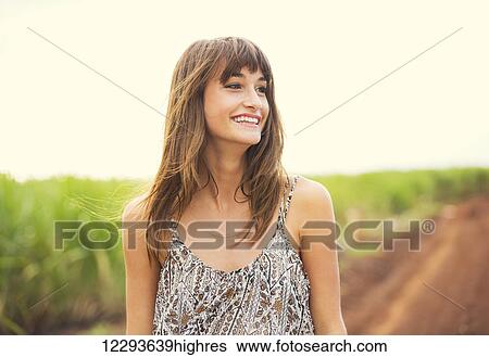 Stock Photograph - Beautiful woman smiling, Happy girl on sunny summer day outside. Laughing and smiling. Carefree healthy lifestyle. Fotosearch