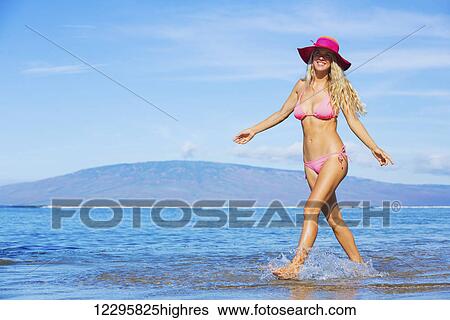 Beautiful woman walking on tropical beach View Large Photo Image Stock Photograph - Beautiful woman walking on tropical beach. Fotosearch
