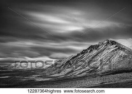 Black and white long exposure of clouds over the Cloudy Range along the Dempster Highway; Yukon, Canada View Large Photo Image Stock Photograph - Black and white long exposure of clouds over the Cloudy Range along the Dempster Highway; Yukon, Canada. Fotosearch