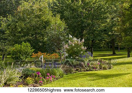 Stock Photograph - Blossoming flowers in a garden; Granby, Quebec, Canada. Fotosearch