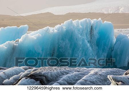 Stock Photograph - Blue icebergs in the ice lagoon of Jokulsarlon along Iceland's south coast; Iceland. Fotosearch