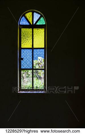 Stock Photograph - Blue, yellow and green stained glass window; Gulu, Uganda. Fotosearch