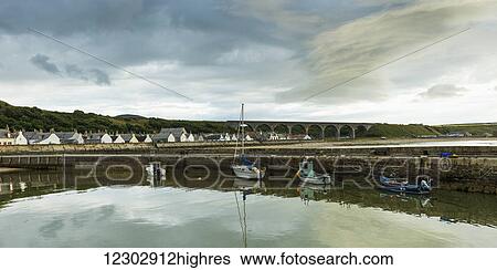 Boats moored in the tranquil harbour of the North Sea with houses in the background; Cullen, Moray, Scotland View Large Photo Image Stock Photograph - Boats moored in the tranquil harbour of the North Sea with houses in the background; Cullen, Moray, Scotland. Fotosearch