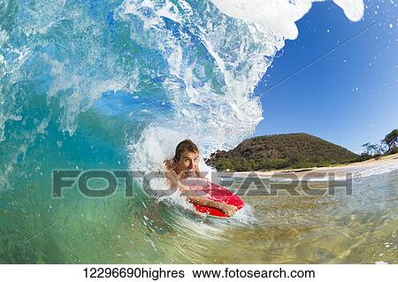 Stock Photograph - Boogie Boarder Surfing Amazing Blue Ocean Wave. Fotosearch