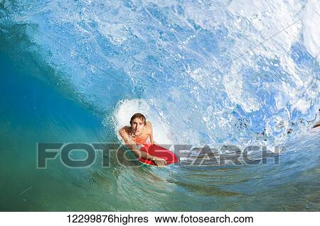 Stock Photograph - Boogie Boarder Surfing Amazing Blue Ocean Wave. Fotosearch
