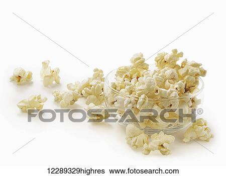 Stock Photograph - Bowl of popcorn in a glass bowl on a white background; Toronto, Ontario, Canada. Fotosearch