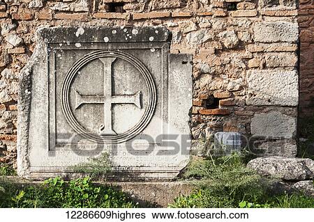 Stock Photograph - Broken stone structure with a cross; Delphi, Greece. Fotosearch