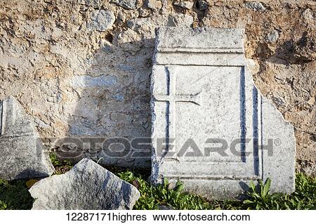 Stock Photograph - Broken stone tablet with cross etched; Philippi, Greece. Fotosearch