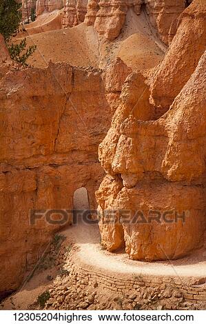 Stock Photograph - Bryce Canyon National Park pathway through carved entrance in the USA; Utah, United States of America. Fotosearch