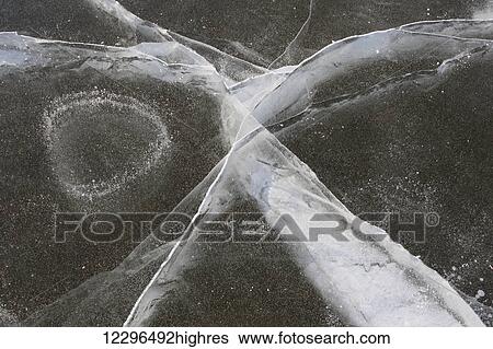 Bubbles in the ice on a small lake; Manitoba, Canada View Large Photo Image Stock Photograph - Bubbles in the ice on a small lake; Manitoba, Canada. Fotosearch