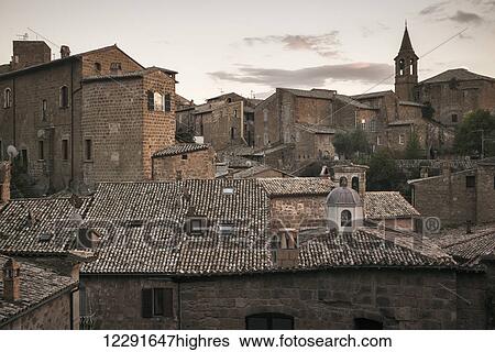 Stock Photograph - Buildings and rooftops with a bell tower; Orvieto, Umbria, Italy. Fotosearch