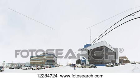 Picture - Buildings and vehicles in a parking lot with snow; Barrow, Alaska, United States of America. Fotosearch