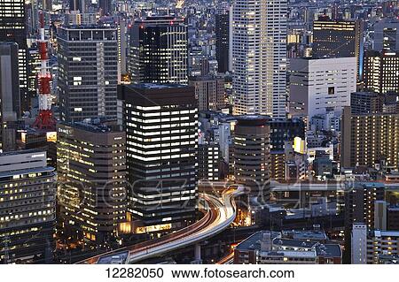 Stock Image - Buildings illuminated at dusk; Kyoto, Japan. Fotosearch