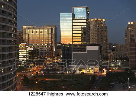 Stock Photograph - Buildings reflecting sunlight at dusk; Dallas, Texas, United States of America. Fotosearch