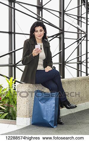 Business woman taking a shopping break during her work day; Edmonton, Alberta, Canada View Large Photo Image Stock Photograph - Business woman taking a shopping break during her work day; Edmonton, Alberta, Canada. Fotosearch