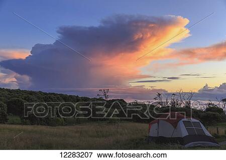 Stock Photo - Camp site at Keanakolu State Park with cumulonimbus sunrise clouds; Island of Hawaii, Hawaii, United States of America. Fotosearch