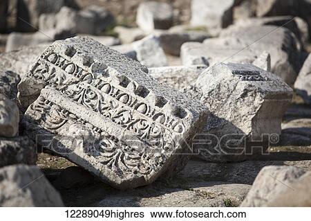 Stock Photograph - Carved detail into a stone at a biblical site; Laodicea, Turkey. Fotosearch