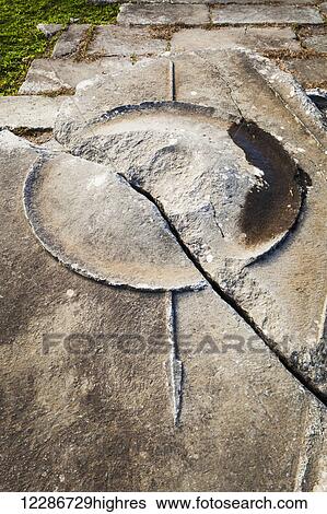 Stock Photograph - Carved shield and spear in rock with a crack; Philippi, Greece. Fotosearch