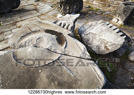 Stock Photograph - Carved shield and spear in rock with a crack; Philippi, Greece. Fotosearch