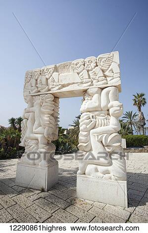 Stock Photograph - Carved white stone structure with images of human figures; Joppa, Israel. Fotosearch