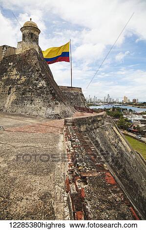 Castillo San Felipe de Barajas and Colombian flag with Cartagena New City in background; Cartagena, Columbia View Large Photo Image Stock Photograph - Castillo San Felipe de Barajas and Colombian flag with Cartagena New City in background; Cartagena, Columbia. Fotosearch