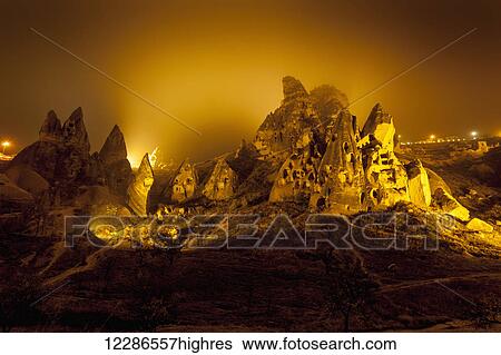 Stock Photograph - Cave homes in rock formations and fairy chimneys; Goreme, Cappadocia, Turkey. Fotosearch