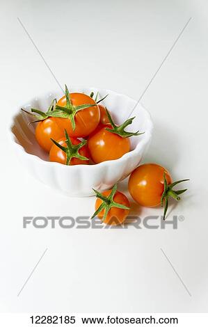 Cherry tomatoes with stems in a white bowl on a white background; British Columbia, Canada View Large Photo Image Stock Photography - Cherry tomatoes with stems in a white bowl on a white background; British Columbia, Canada. Fotosearch