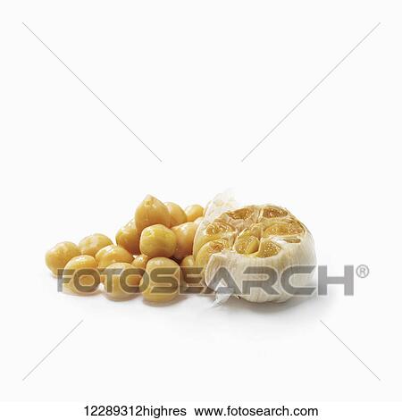 Chick peas and cloves of garlic on a white background; Toronto, Ontario, Canada View Large Photo Image Stock Photograph - Chick peas and cloves of garlic on a white background; Toronto, Ontario, Canada. Fotosearch