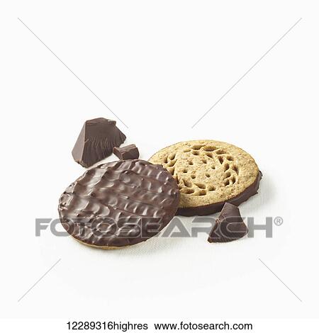 Stock Photograph - Chocolate covered cookies with pieces of chocolate on a white background; Toronto, Ontario, Canada. Fotosearch