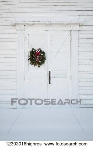Stock Photograph - Christmas wreath on front door of church; Hatley, Quebec, Canada. Fotosearch